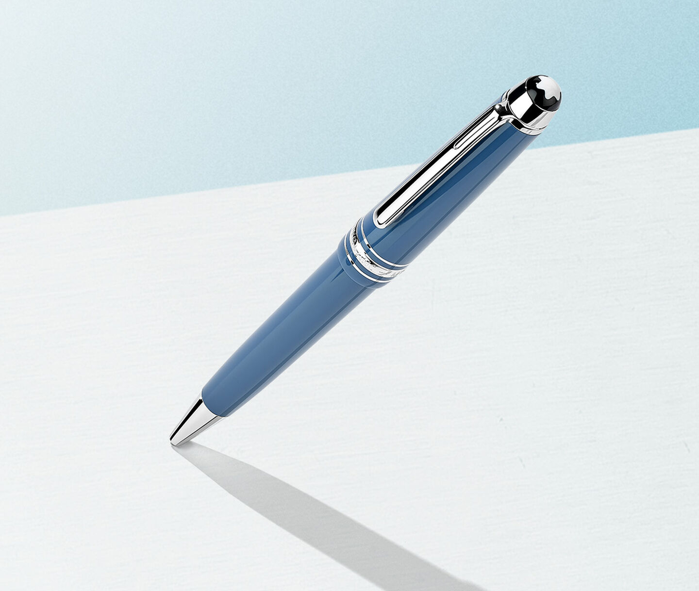 Montblanc pen on a light blue background.